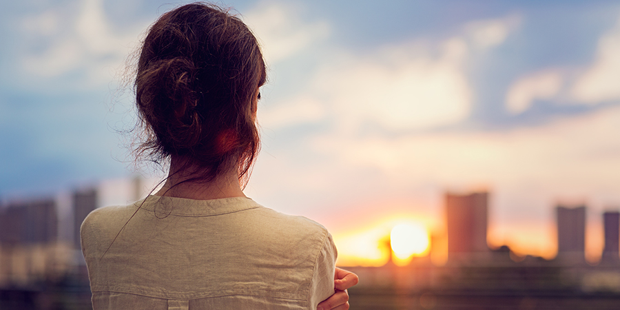 Woman looking out at sunset
